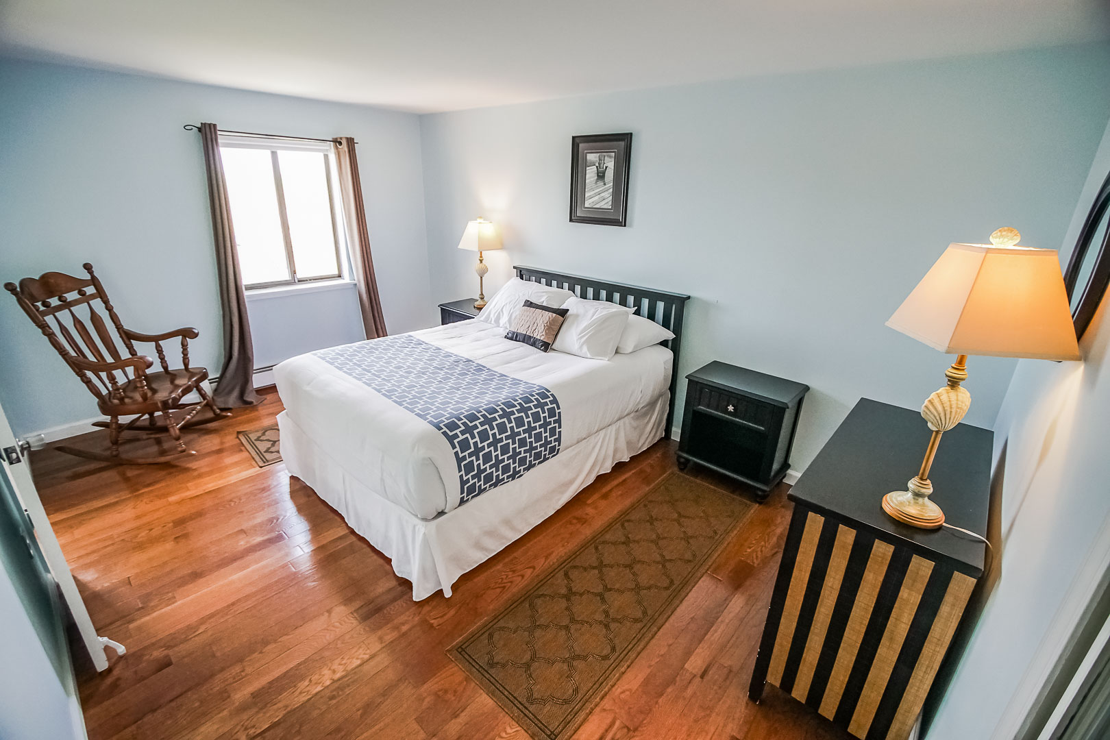 A spacious master bedroom  at VRI's Neptune House Resort in Rhode Island.